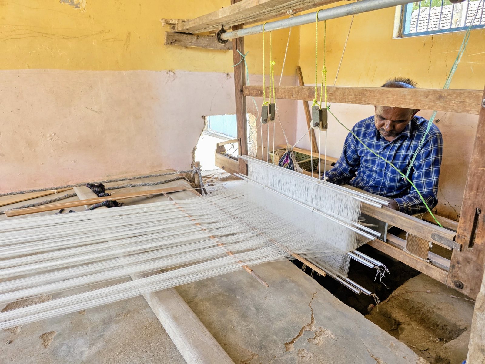 Karshan Bhimji setting the warp on a traditional handloom in Kutch, Gujarat