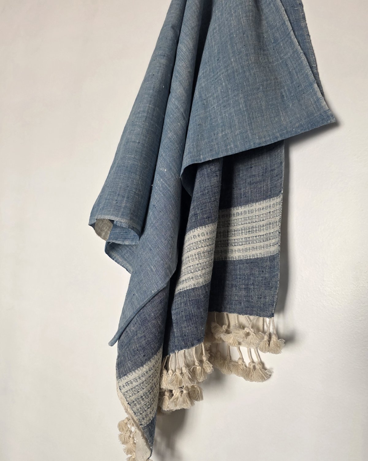 Rannova indigo Kala cotton stole, hanging drape showing the woven border and hand-tied tassels